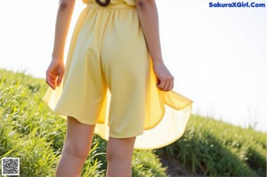 A woman wearing a white top and floral skirt.