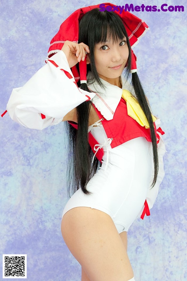 A woman in a white and red outfit posing for a picture.