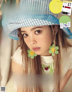 A woman with long hair wearing a blue and white hat.