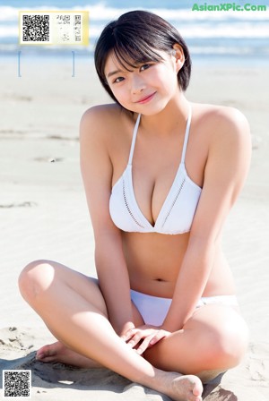 A woman in a blue bikini posing for the camera.