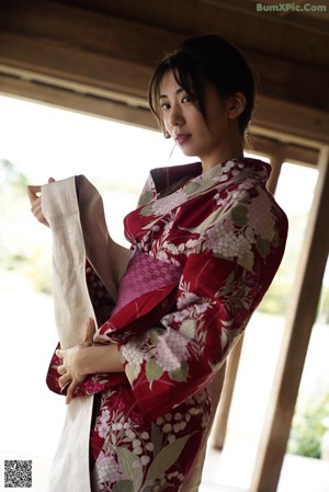 A woman in a kimono laying on the floor.