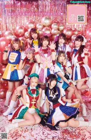 A group of young women dressed in colorful outfits posing for a picture.