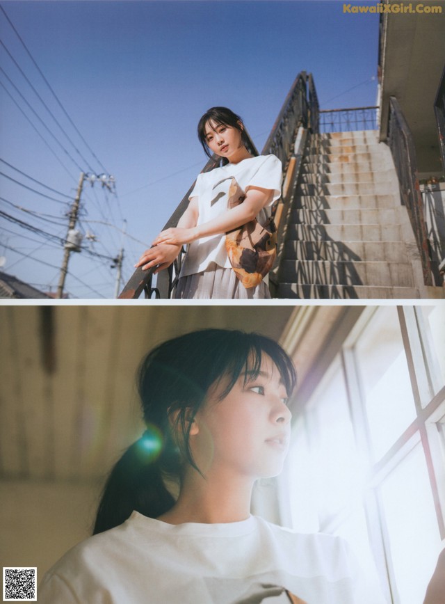 A woman standing on a stairway next to a window.