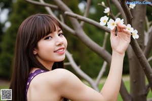 A naked asian woman standing in front of a door.