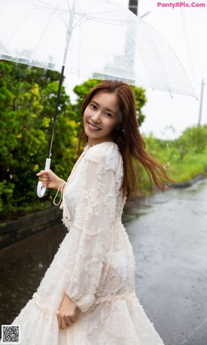 A woman with long brown hair smiles at the camera.