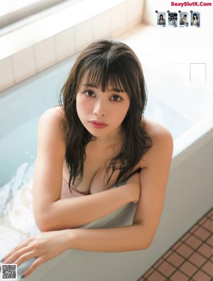 A woman in a white lingerie holding a white teddy bear.