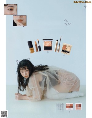 A woman sitting on top of a toilet next to a magazine.
