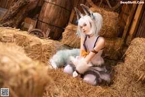 A woman in a white and blue outfit holding a stuffed animal.