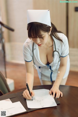 A woman in a nurse outfit sitting on a chair.