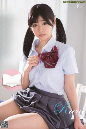 A young woman sitting on top of a wooden table.